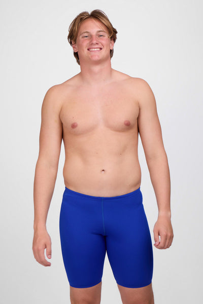 Male model wearing the Men's BROLYN Jammer in the Blueberry solid, standing in front of a grey background, shown from front view. 