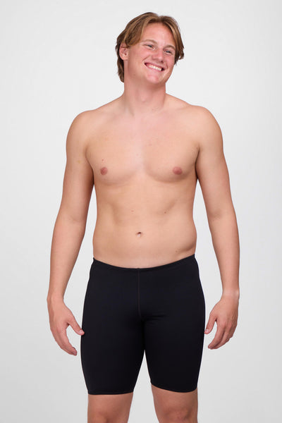 Male model wearing the Men's BROLYN Jammer in the Black solid, standing in front of a grey background, shown from front view. 