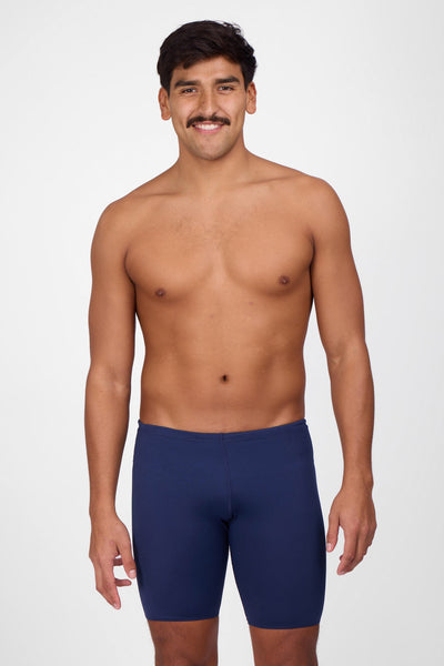Male model wearing the Men's BROLYN Jammer in the Navy solid, standing in front of a grey background, shown from front view. 