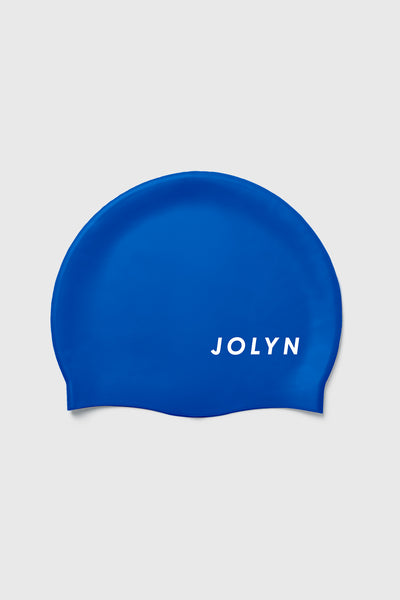 Up close image of the Silicone Swim Cap in the Blueberry solid, in front of a grey background, shown from the front view