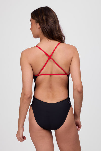 Female model wearing the Women's Brandon One Piece Swimsuit in the Black and Red contrast, standing in front of a white background, shown from back view.
