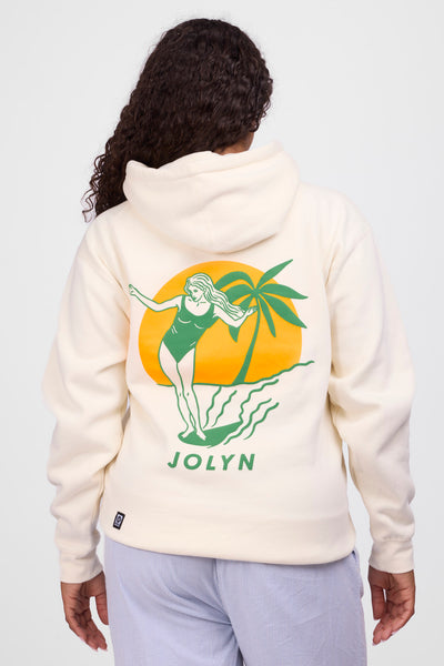 Female model wearing the Womens Raine Hoodie in the Vibin Bone solid, standing in front of a grey background, shown from the back view