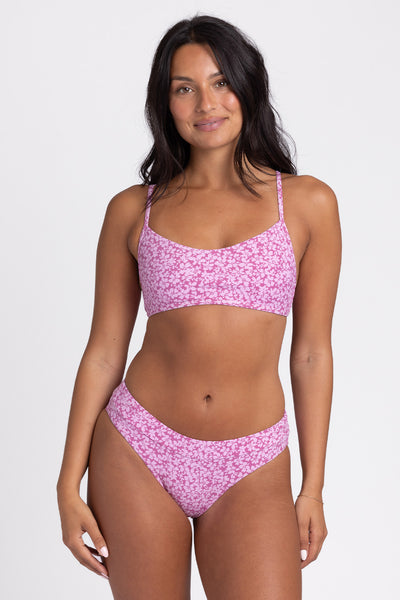 
Female model wearing the Women's Alanna Bikini Bottom in the Calypso print, standing in front of a grey background, shown from front view.  