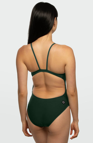 
Female model wearing the Women’s Devon One Piece Swimsuit in the Peacock solid, standing in front of a grey background, shown from the back view