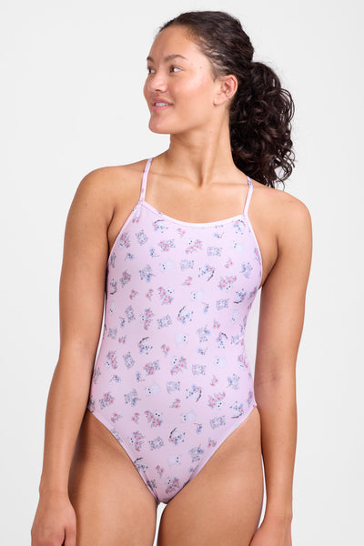 Female model wearing the Women's Perry One Piece Swimsuit in the Kittens print, standing in front of a grey background, shown from the front view. 
