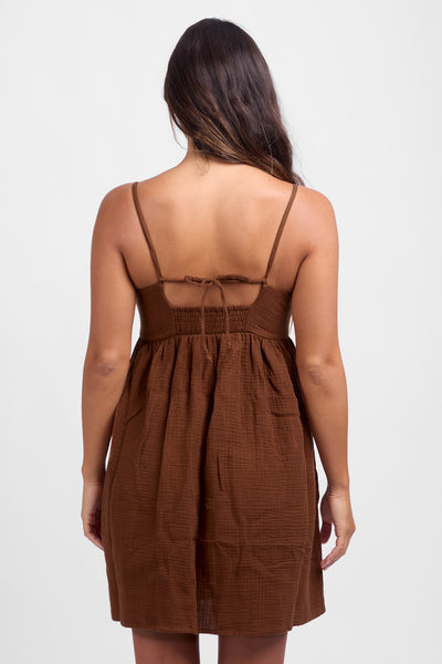 
Female model wearing the Women's Amy dress in the Coconut solid color, standing in front of a white background, shown from the back view.