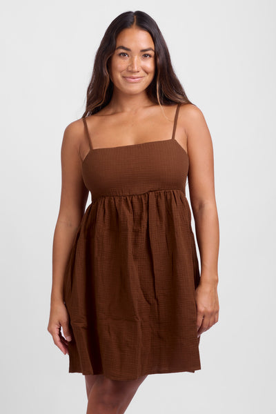 
Female model wearing the Women's Amy dress in the Coconut solid color, standing in front of a white background, shown from the front view.