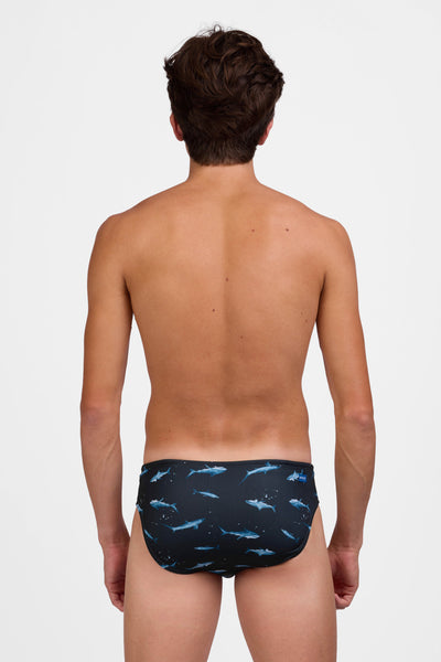 Male model wearing the Mens Brolyn Swim Brief in the Shortfin print standing in front of a grey background, shown from the back view 

|| Size 32, Hips 29"  