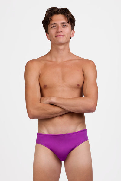 Male model wearing the Men's Brolyn Swim Brief in the Solar Plum solid, standing in front of a grey background shown from the front view

|| Size 32, Hips 39"  