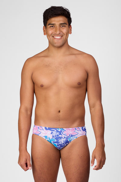 Male model wearing the Men's Brolyn Swim Brief in the Maui print, standing in front of a grey background shown from the front view

