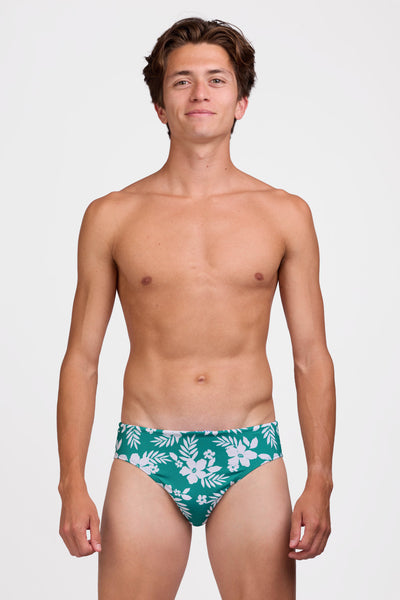 Male model wearing the Men's Brolyn Swim Brief in the Tropical Island print, standing in front of a grey background shown from the front view

|| Size 32, Hip 29"  