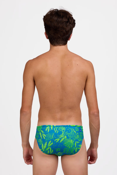 Male model wearing the Mens Brolyn Swim Brief in the Undersear print standing in front of a grey background, shown from the back view 

|| Size 32, Hips 29"  