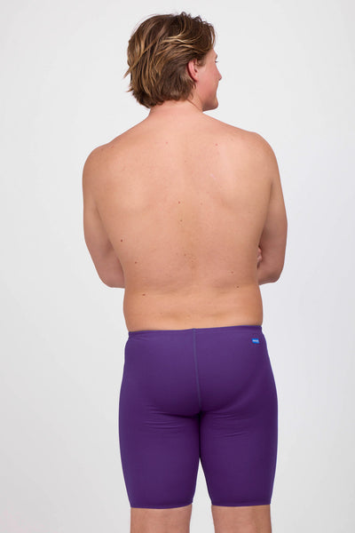 Male model wearing the Mens Brolyn Jammer in the Grape solid standing in front of a grey background, shown from the back view