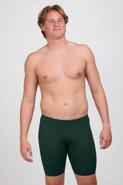 Male model wearing the Men's Brolyn Swim Jammer in the Pine solid, standing in front of a grey background shown from the front view