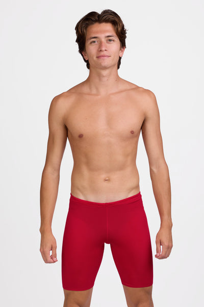Male model wearing the Men's BROLYN Jammer in the Red solid, standing in front of a grey background shown from the front view