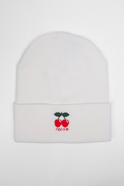 Up close image of the Unisex beanie in the cherries print, in front of a grey background, shown from the front view