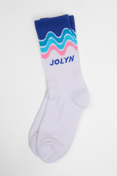 Up close image of the Unisex crew socks in the Currents print, in front  of a grey background, shown from the side view