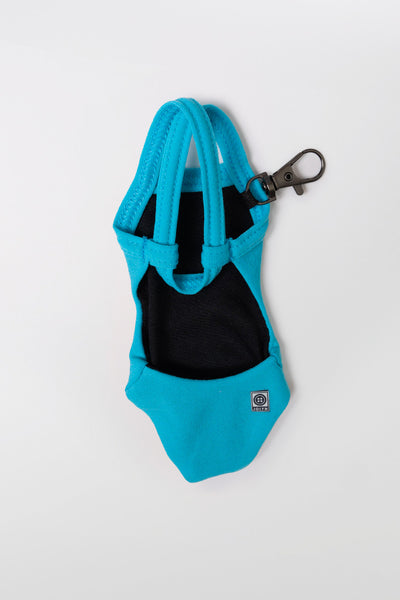 Flat lay image of the Mini Me Brandon Keychain in the Caribbean solid, in front of a grey background shown from the back view