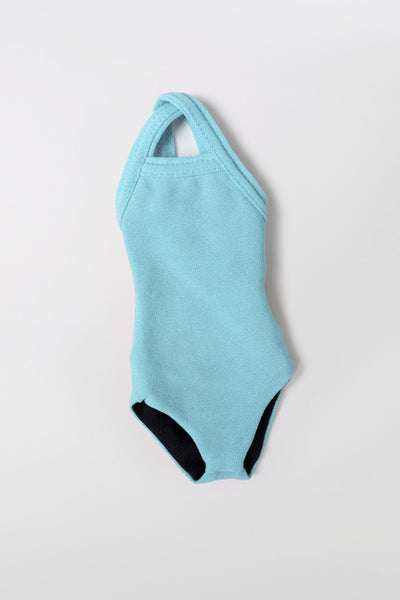 Flat Lay image of Mini Me Brandon Keychain in the Huckleberry Solid, in front of a grey background, shown from the front view