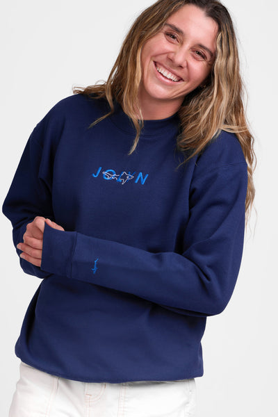 Female model wearing the Women's Roxanne Crewneck in the Navy Shark solid, standing in front of a grey background shown from the front view

|| Size S, Bust 36"  