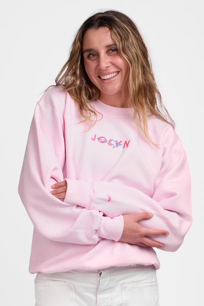 Female model wearing the Women's Roxanne Crewneck in the Pink Shark solid, standing in front of a grey background shown from the front view

|| Size S, Bust 36"  