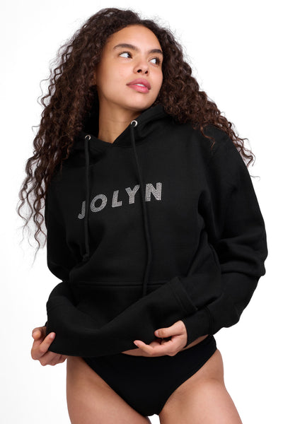 Female model wearing the Women's Raine Hoodie in the Bling solid, standing in front of a grey background shown from the front view

|| Size S, Bust 32"