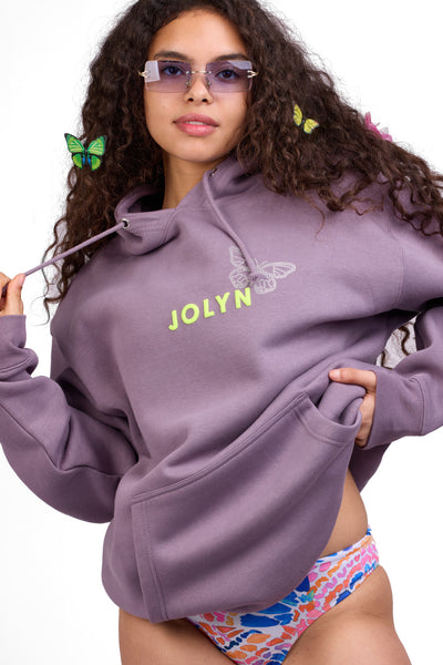 Female model wearing the Women's Raine Hoodie in the Buddaflies solid, standing in front of a grey background shown from the front view

|| Size S, Bust 32"