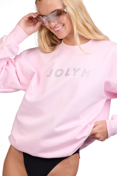 Female model wearing the Women's Roxanne Crewneck in the Bling solid, standing in front of a grey background shown from the front view

|| Size S, Bust 32"