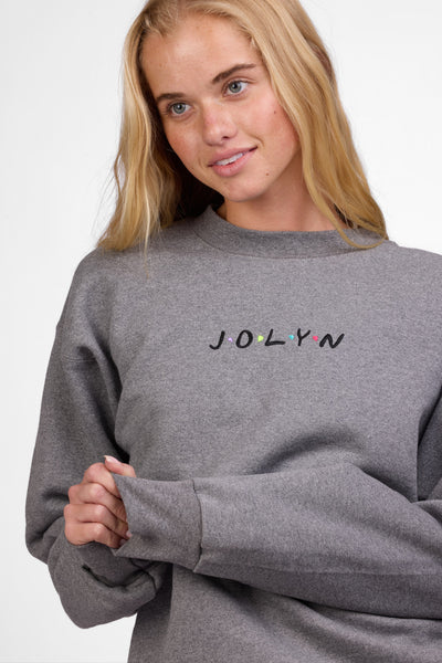 Female model wearing the Women's Roxanne Crewneck in the Fwends solid, standing in front of a grey background shown from the front view

|| Size S, Bust 32"