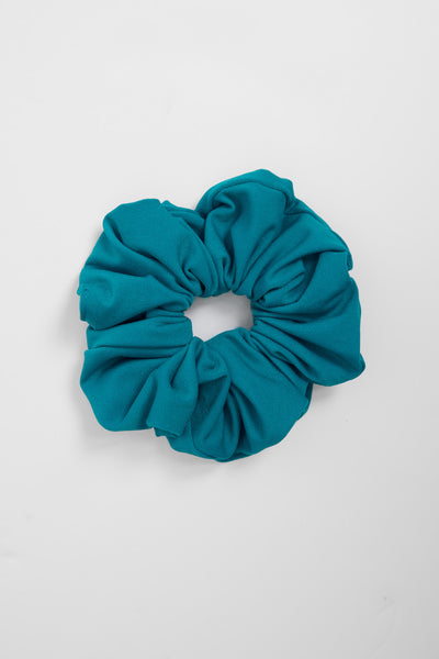 Flat lay image of unisex hair scrunchie in the Dew solid, in front of a grey background