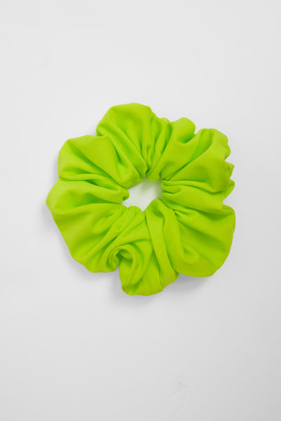 Flat lay image of unisex hair scrunchie in the Gecko solid, in front of a grey background