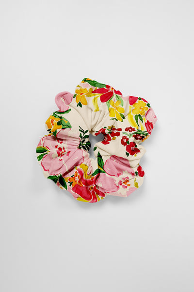Flat Lay image of a Scrunchie in the Sunset Luau print, on top of a grey background, shown from the front view