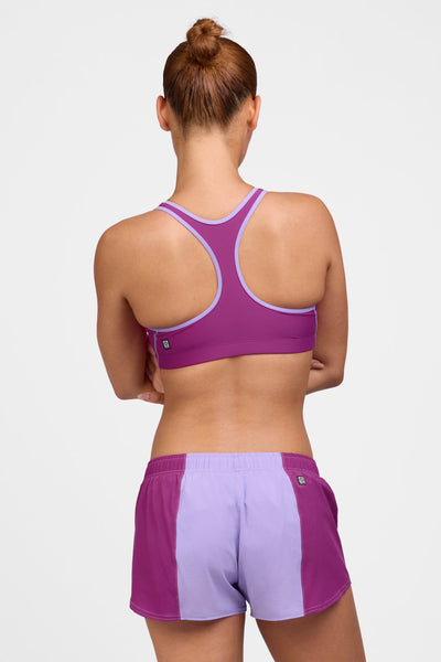 Female model wearing the Women's Rory Short in the Lilac Haze contrast, standing in front of a grey background shown from the back view 

|| Size M, Hip 38"