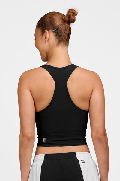 Female model wearing the Women's Rochelle Tank in the Black solid, standing in front of a grey background shown from the back view 

|| Size M, Bust 35"