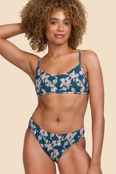 Female model wearing the Womens Alanna Bikini Bottom in the Islander Ribbed print, standing in front of a yellow background shown from the front view

|| Size S, Hip 36"  