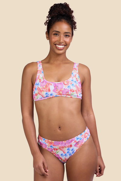 Female model wearing the Women's Alanna Bikini Bottom in the Orchids Ribbed print, standing in front of a yellow background shown from the front view

|| Size S, Hips 37" 