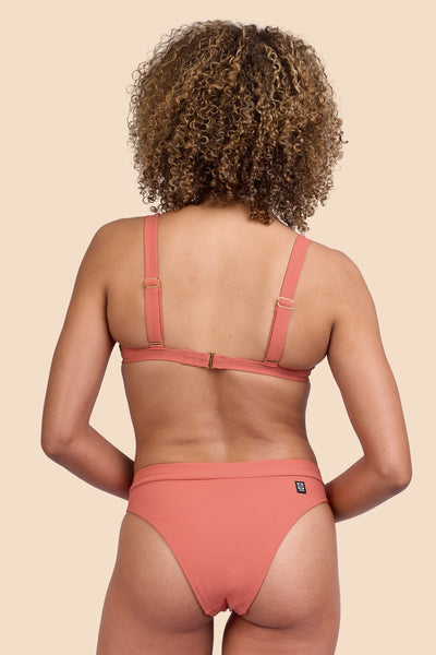 Female model wearing the Women's Alanna Bikini Bottom in the Serrano Ribbed solid, standing in front of a yellow background, shown from the back view

|| Size S, Hip 36" 