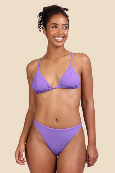 Female model wearing the Women's Ava Bikini Bottom in the Jam Ribbed solid, standing in front of a yellow background shown from the front view

|| Size S, Hips 37"  
  