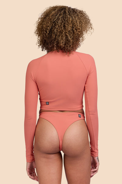 Female model wearing the Women's Ava Bikini Bottom in the Serrano Ribbed solid, standing in front of a yellow background, shown from the back view

|| Size S, Hip 36" 