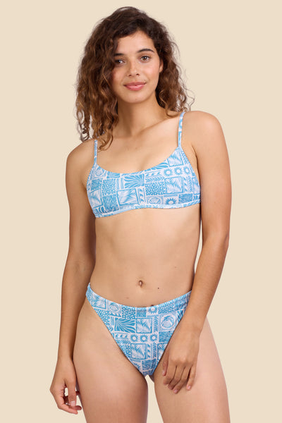 Female model wearing the Women's Ava Bikini Bottom in the Swell print, standing in front of a yellow background shown from the front view

|| Size S, Hips 39" 