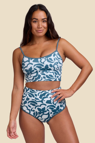 Female model wearing the Women's Aveline Bikini Bottom in the Sumatra print, standing in front of a yellow background shown from the front view

|| Size S, Hips 35"  