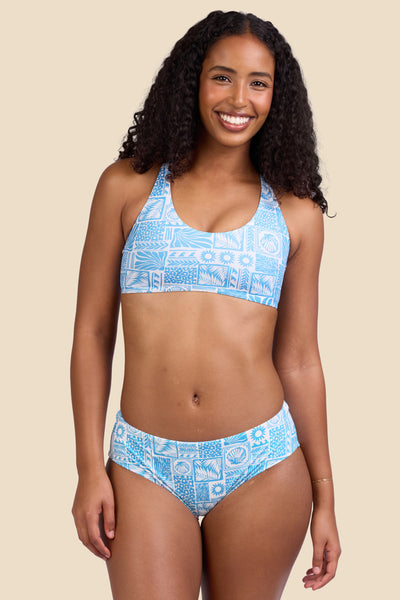 Female model wearing the Women's Dakota Bikini Bottom in the Swell print, standing in front of a yellow background shown from the front view

|| Size S, Hips 37" 
