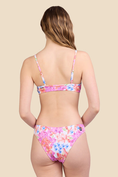 Female model wearing the Women's Gina Bikini Bottom in the Orchids Ribbed print, standing in front of a yellow background shown from the back view

|| Size S, Hips 37" 
