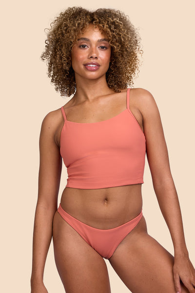 Female model wearing the Women's Kelia Bikini Bottom in the Serrano Ribbed solid, standing in front of a yellow background, shown from the front view

|| Size S, Hip 36" 