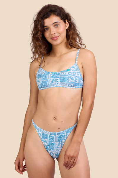 Female model wearing the Women's Odessa Bikini Bottom in the Swell print, standing in front of a yellow background shown from the front view

|| Size S, Hips 39" 
