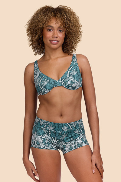 Female model wearing the Womens Piha Surf Short in the Shorebreak print, standing in front of a yellow background shown from the front view

|| Size S, Hip 36"  