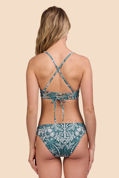 Female model wearing the Womens Valle Bikini Bottom in the Shorebreak print, standing in front of a yellow background shown from the back view

|| Size S, Hip 36"  