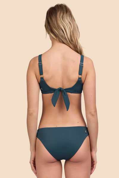 Female model wearing the Women's Valle Bikini Bottomin the Underwater solid, standing in front of a yellow background shown from the back view

|| Size S, Hip 36"  