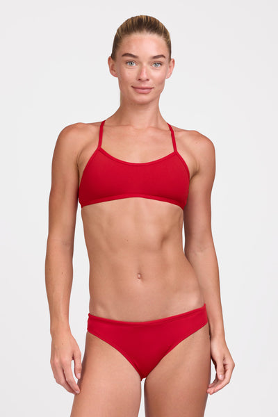 Female model wearing the Women's Andy Bikini Bottom in the Red solid, standing in front of a grey background shown from the front view

|| Size S, Hips 37"
