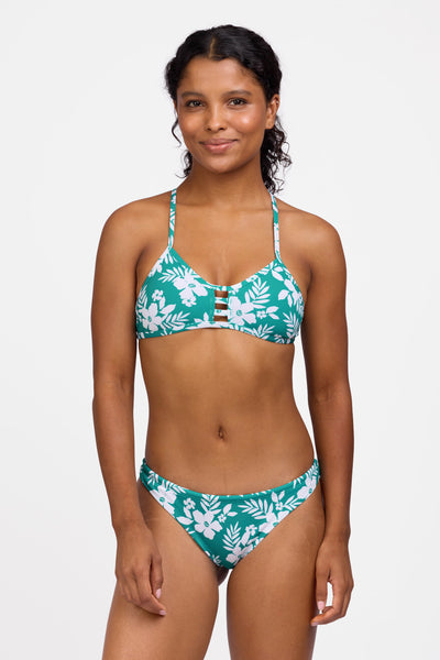 Female model wearing the Women's Dreya Bikini Bottom in the Tropical Island print, standing in front of a grey background shown from the front view

|| Size S, Hip 36.5"  
